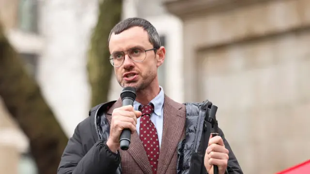 Gabriel Shipton, brother of Julian Assange, speaks to supporters outside the High Court in London