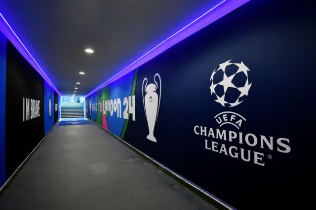 The tunnel at San Siro with the UCL branding.