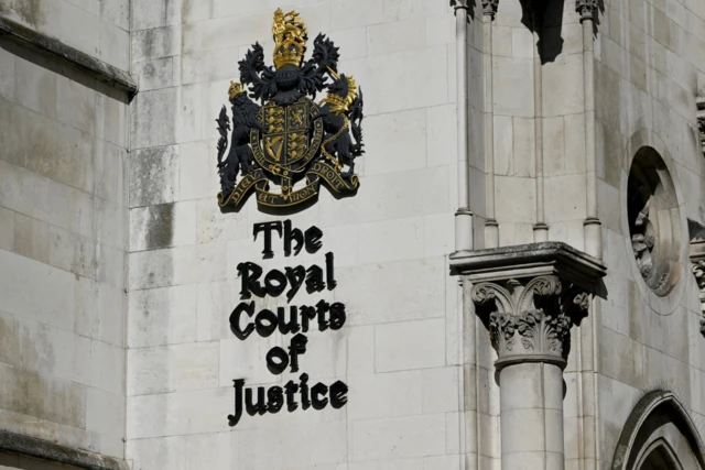 A general view shows a signage at the High Court in London