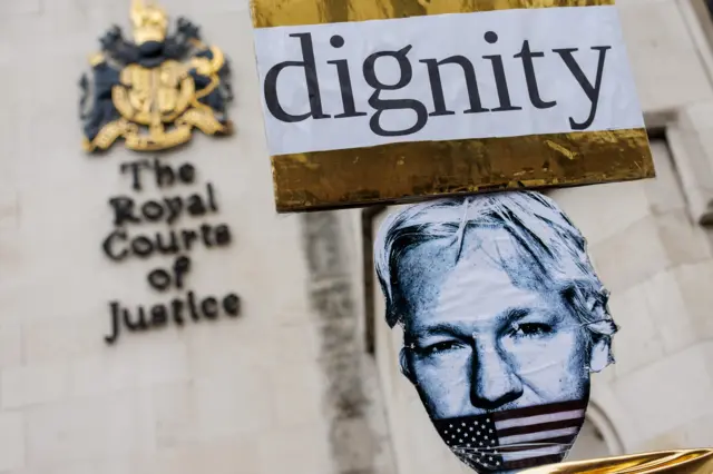 Picture of a poster that reads "dignity" outside the Royal Courts of Justice