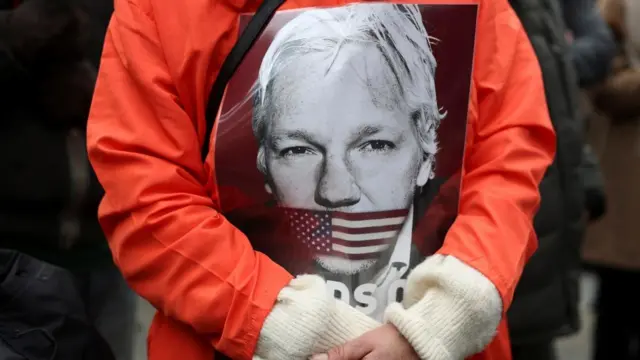 A supporter of WikiLeaks founder Julian Assange stands outside the high court on the day Assange appeals against his extradition