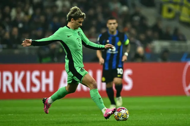 Griezmann looks to play a ball forward in midfield.