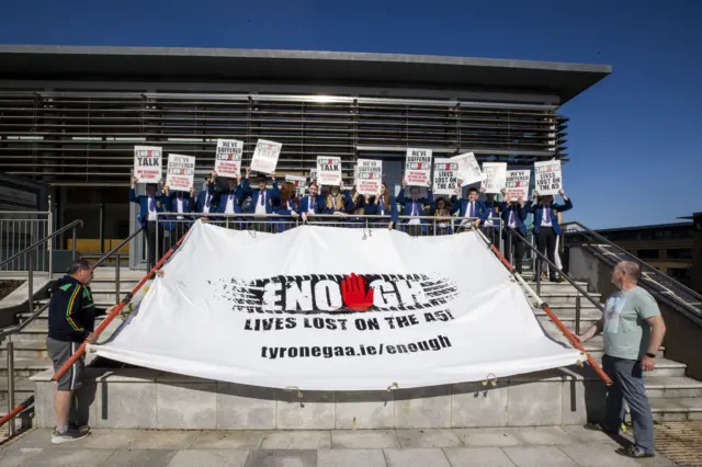 Members of the A5 Enough is Enough group hold up a banner