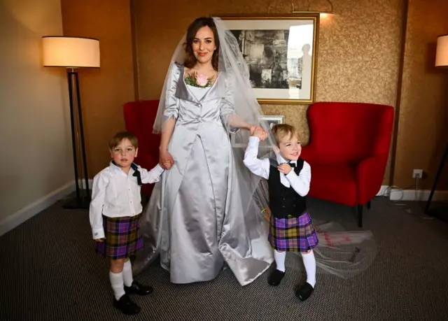 Stella Moris is photographed with her sons Max, 3, and Gabriel, 4, in her Vivienne Westwood designed wedding dress before driving to Belmarsh Prison to marry Julian Assange at a hotel in London on 23 March, 2022