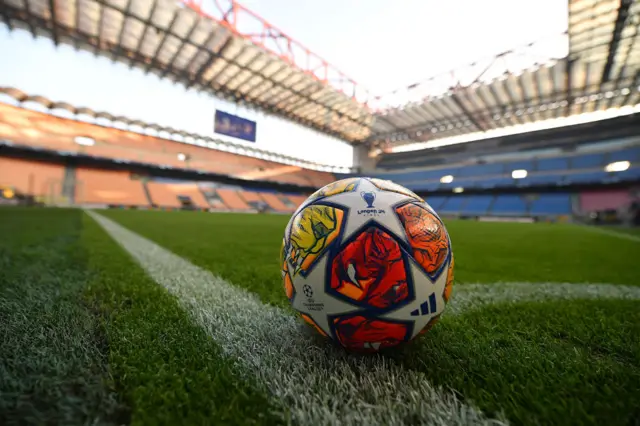 A match ball stands ready for use on the corner of the San Siro turf.