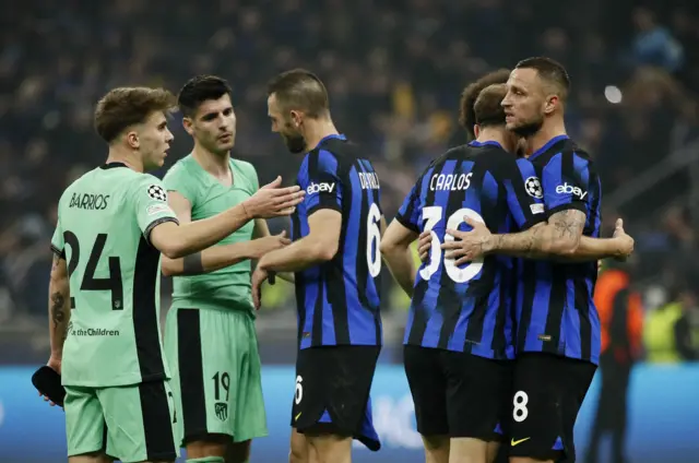 Inter and Atletico players shake hands at full time.