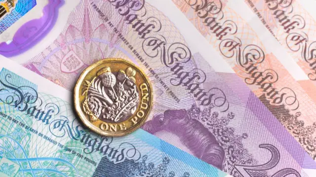 British notes and a pound coin