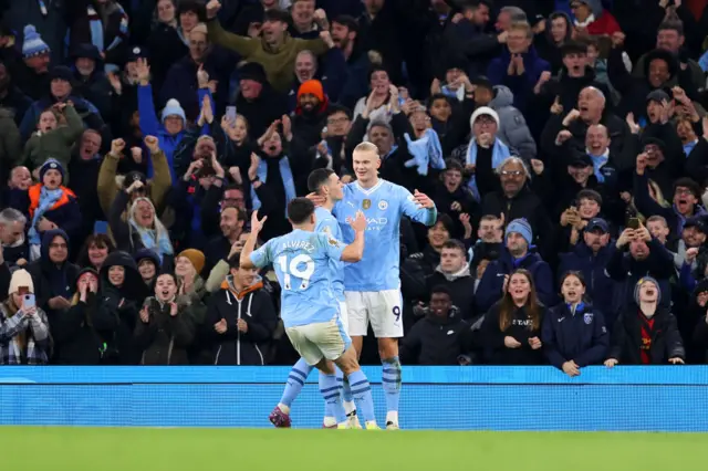 Julian Alvarez and Phil Foden celebrate with Erling Haaland