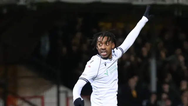 Paris Maghoma celebrates scoring for Bolton at Cambridge