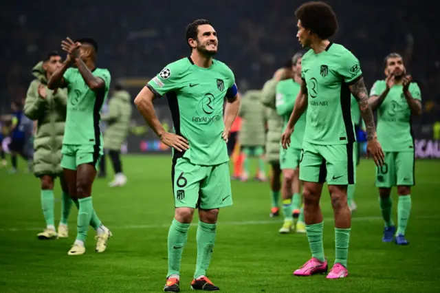 Koke stands with his hands on his hips as Atletico salute their fans after defeat in Milan.