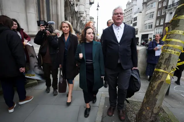 Picture of Stella Assange, wife of Julian Assange, the founder of WikiLeaks, Assange's lawyer Jennifer Robinson, and WikiLeaks editor in chief, Kristinn Hrafnsson, walking outside the High Court