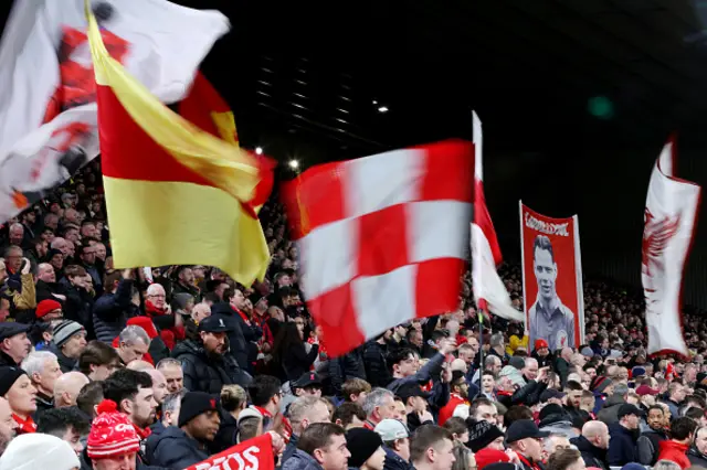 Fans of Liverpool show their support with flags