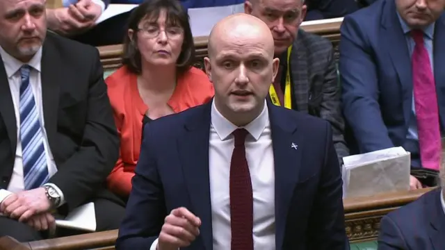 Stephen Flynn stands at the House of Commons during PMQs