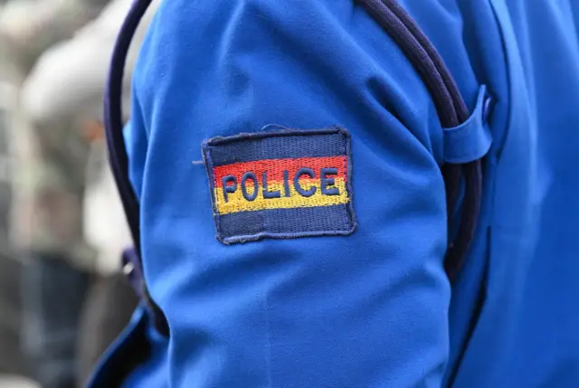 The chevron Police on the sleeve of a blue police suit in Nairobi. Kenya