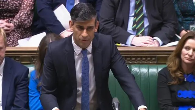 Rishi Sunak stands at Prime Minister Questions