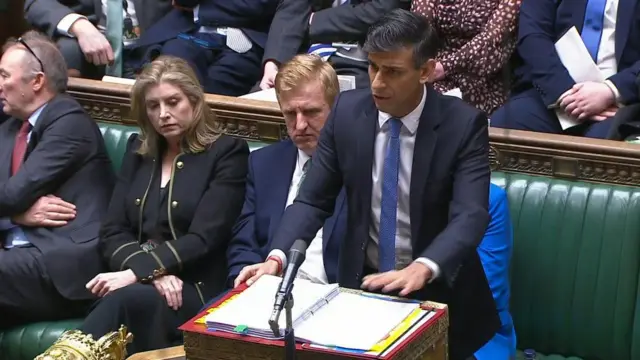 Rishi Sunak stands at the House of Commons during PMQ