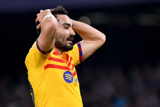 Gundogan puts his hands on his head in frustration.