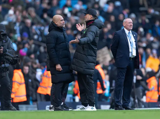 Manchester City manager Pep Guardiola and Liverpool manager Jurgen Klopp exchange words