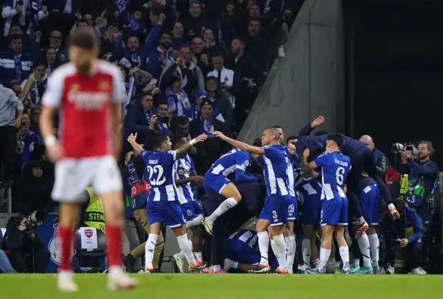 Porto players celebrate as Jorginho stands in the foreground stunned.