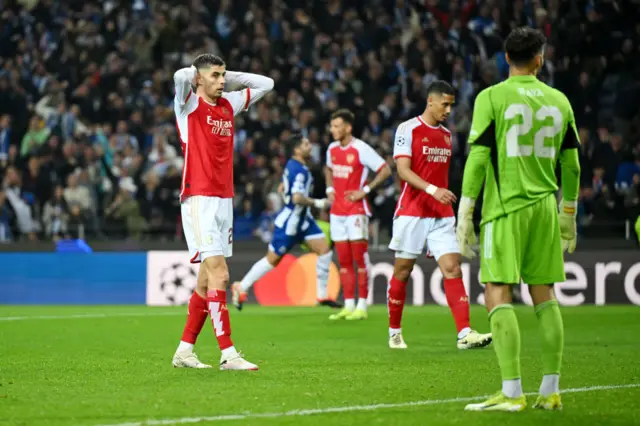 Arsenal players stand stunned after conceding a late winner.