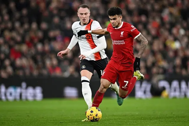 Luis Diaz (R) runs with the ball