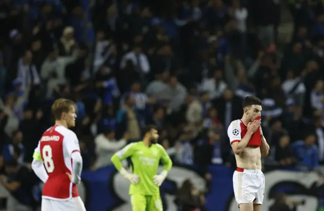 Arsenal players stand stunned after losing in added time.