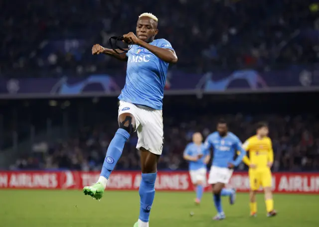 Victor Osimhen fist pumps mid air to celebrate equalising for Napoli.