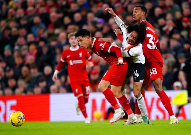 Tahith Chong battles for the ball with Liverpool's Wataru Endo and Ryan Gravenberch