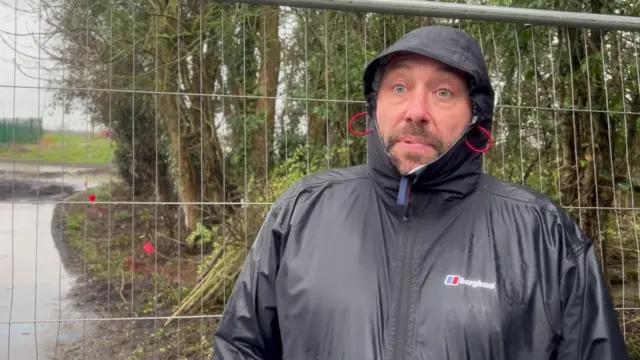 Andrew Collinson by the construction fence