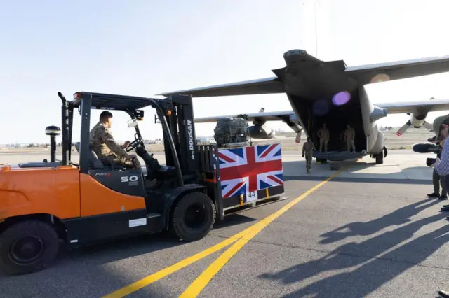 Image of UK and Jordanian humanitarian aid for Gaza is loaded onto a Jordanian Air Force aircraft to be air-dropped into northern Gaza