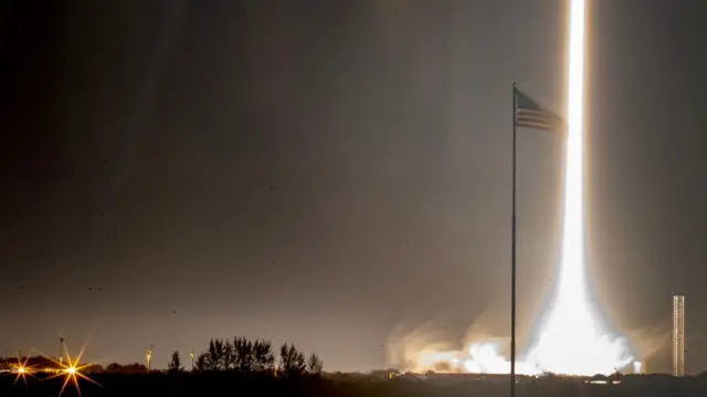 A flash of light is seen where the rocket took off