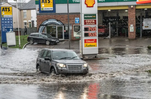 Car in flood water in Stafford