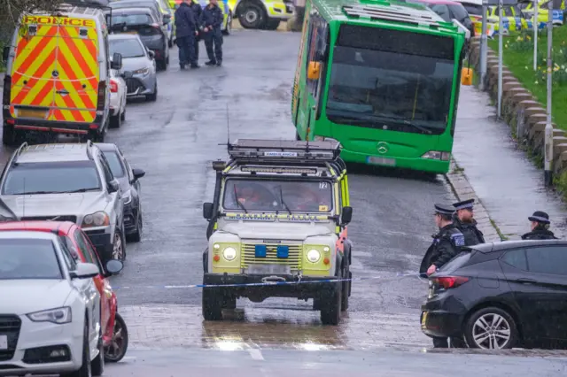 Members of Dartmoor Rescue Group by the police cordon after a suspected Second World War explosive device was discovered in a garden on St Michael Avenue in Plymouth