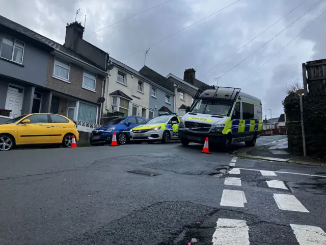 Police vehicles at the cordon in Keyham