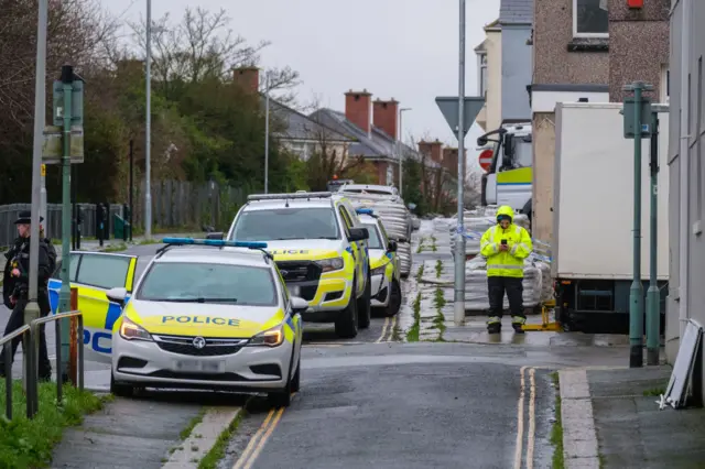 Police cars parked inside the cordon