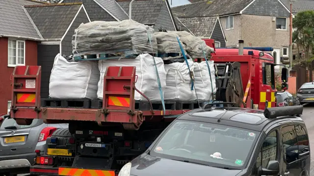 A fire truck carrying sand bags in Plymouth