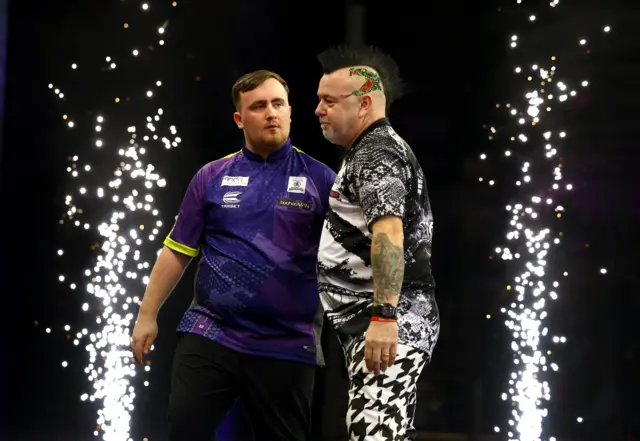 Luke Wright commiserates Peter Wright after beating him in the Premier League of Darts night in Newcastle