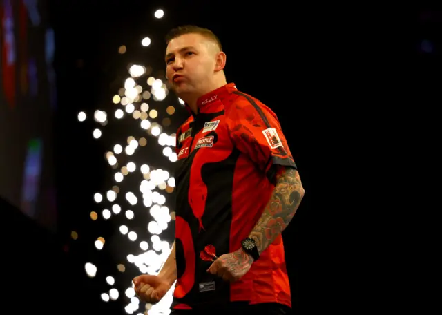 Nathan Aspinall celebrates beating Rob Cross