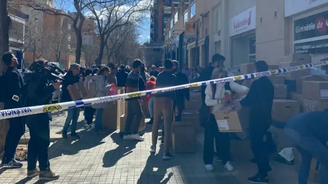 People  make donations to the victims of a fatal fire in Valencia, Spain