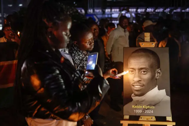 People attend a candle light vigil for the late Kenyan marathon runner Kelvin Kiptum in Nairobi, on February 22, 2024