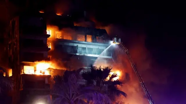 Firefighters work at the scene of a fire at an apartment building in Valencia, Spain February 22, 2024.