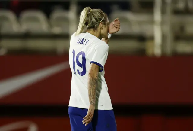 Daly kisses her armband that reads 'Dad' to dedicate her goal to her late father.