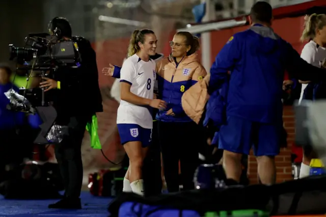 Wiegman congratulates Clinton after substituting her.