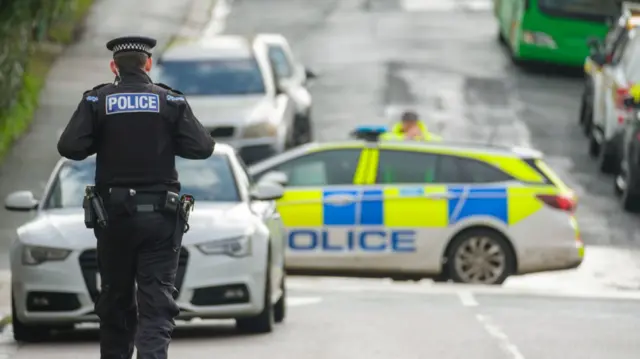 Police officers at a cordon after homes were evacuated