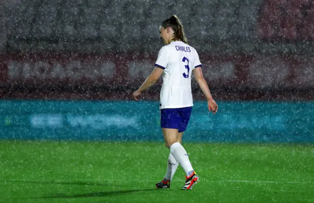 Charles is drenched by the downpour of rain.