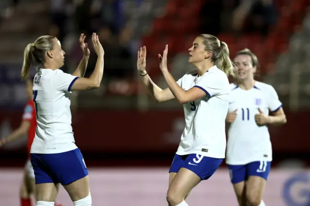 Mead and Russo high five after the latter opens the scoring for England.