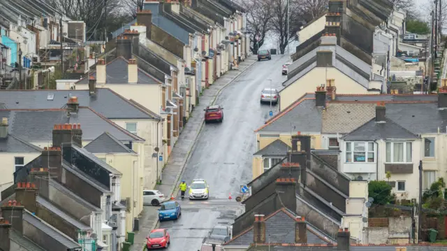 A police officer stands at a cordon after homes were evacuated