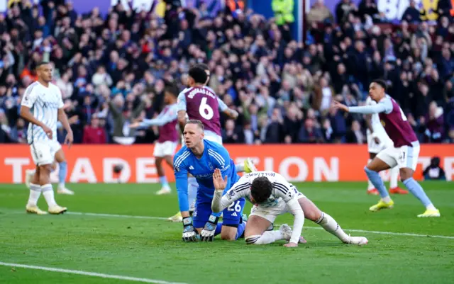 Matz Sels and team-mate look dejected as Aston Villa's Douglas Luiz (behind) celebrates scoring