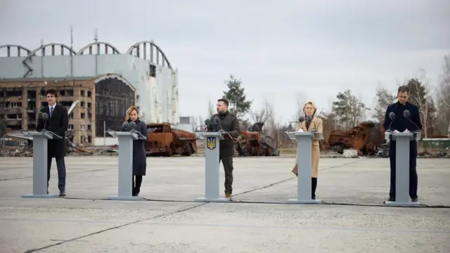 Ukraine's President Volodymyr Zelensky, European Commission President Ursula von der Leyen, Italian Prime Minister Giorgia Meloni, Belgium's Prime Minister Alexander De Croo and Canada's Prime Minister Justin Trudeau speak at an airfield in Hostomel