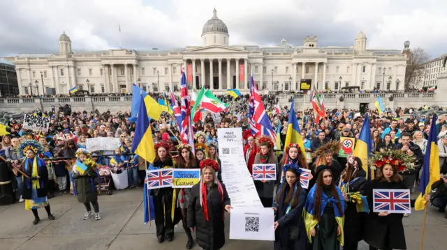 A huge crowd of people with Ukrainian flags in London's Trafalgar Square